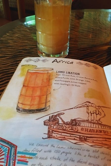 Nomad Lounge in Animal Kingdom Lamu Libation in front of menu. Keep reading to get the best drinks at Animal Kingdom in Walt Disney World.