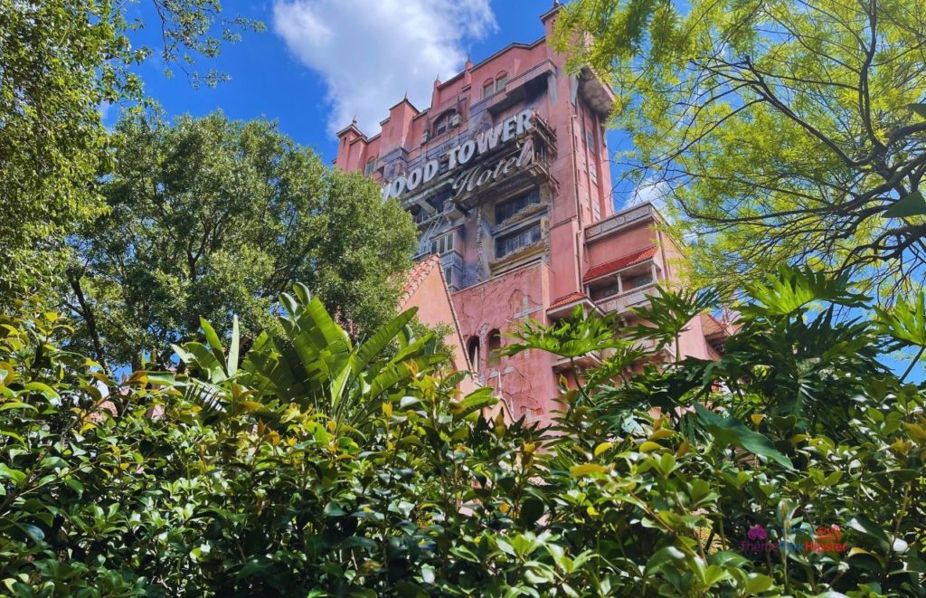 Overgrown palms outside the façade of The Hollywood Tower Hotel, home of The Twilight Zone Tower of Terror. Keep reading to get the best rides at Hollywood Studios for Genie Plus and Lightning Lane attractions.