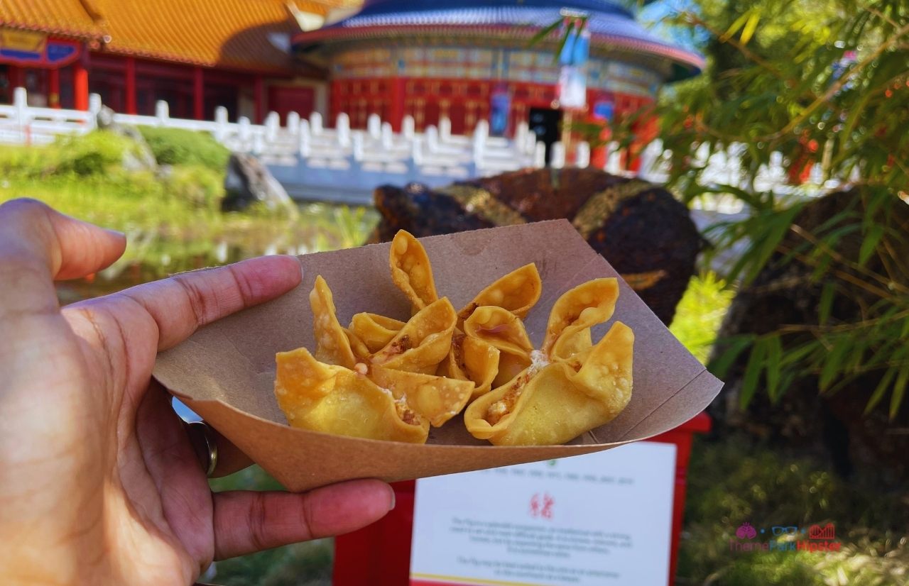 Epcot China Pavilion Flower and Garden Festival Cheese Wontons overlooking temple. Keep reading to get the best things to do at Epcot Flower and Garden Festival.
