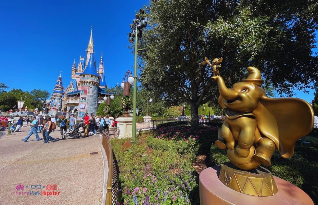 Disney Magic Kingdom Cinderella Castle with Dumbo 50th Anniversary statue. Keep reading if you want to find out more about how to choose the best purse for Disney.
