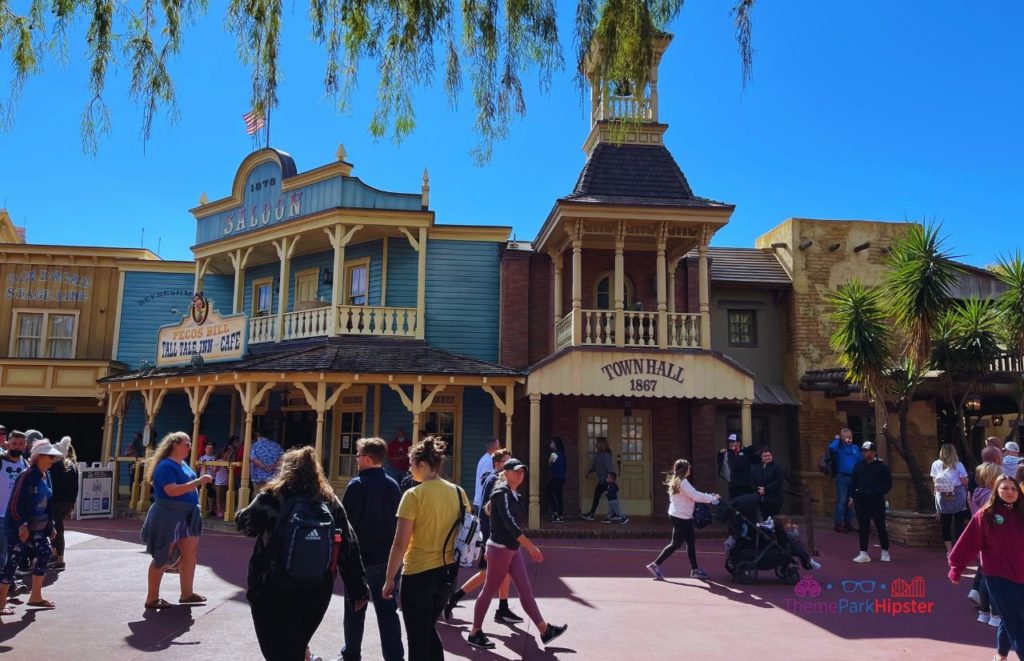 Frontierland town hall next to Pecos Bill Tall Tale Café in pioneer era design at Disney Magic Kingdom. Keep reading to discover more about the best place to watch Magic Kingdom fireworks.