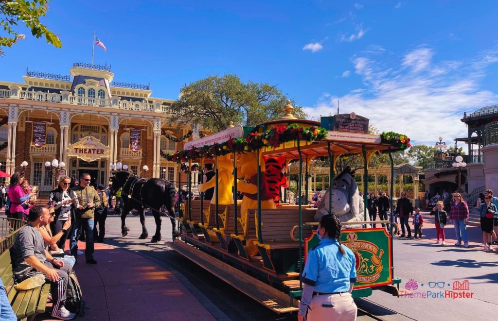 Disney Magic Kingdom Holiday Christmas Trolley with Winnie the Pooh Tigger in front of Theater