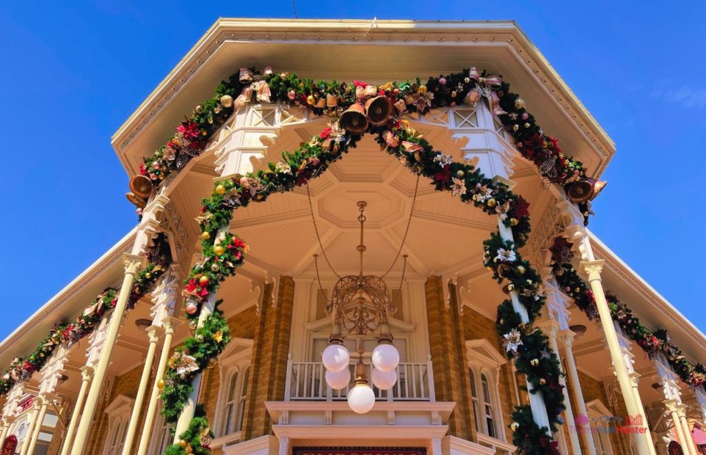 Disney Magic Kingdom Holiday Decor on Main Street USA. Keep reading to get the best things to do at the Magic Kingdom for Christmas and a full guide to Mickey's Very Merry Christmas Party Tips!