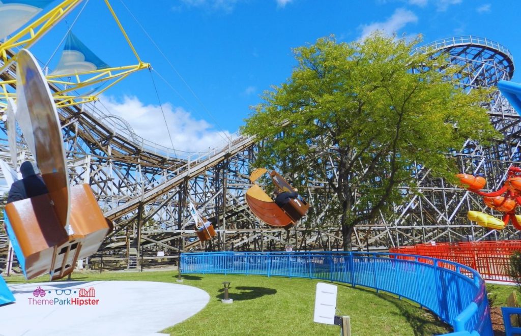 Cedar Point Gemini Wooden Roller Coaster next to kid rides. Keep reading for more Cedar Point Solo Travel Tips!