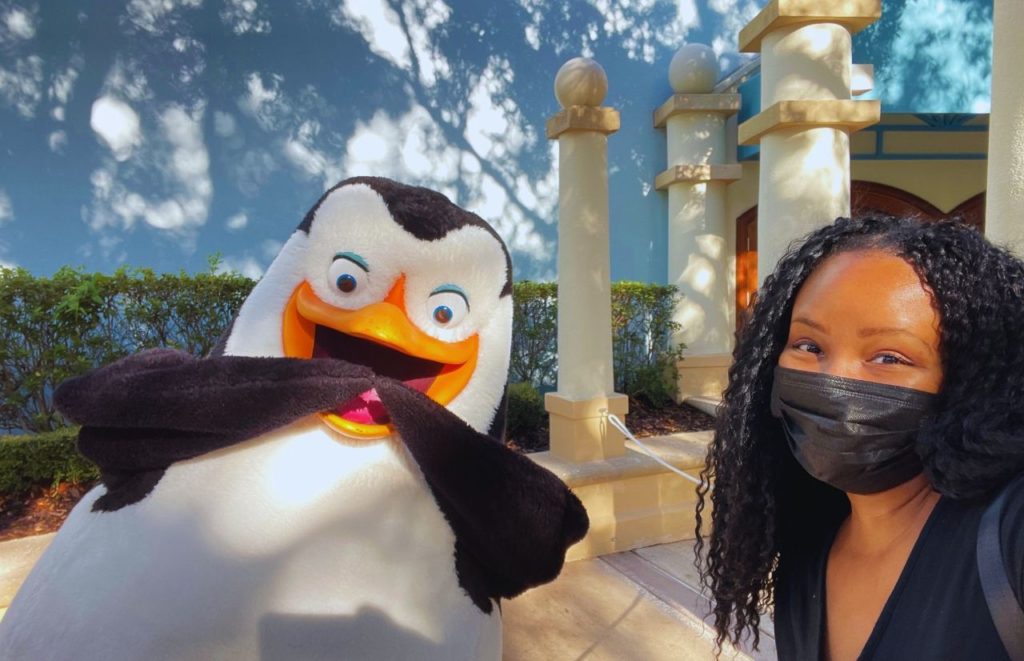Nikky J at Universal Orlando Resort Dreamworks Destination at Universal Studios Florida Characters with penguin character of Penguins of Madagascar. 