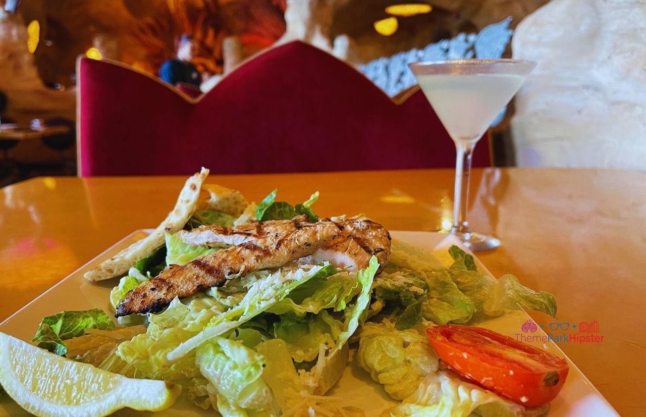 Universal Orlando Resort Mythos Restaurant at Islands of Adventure Chicken Caesar Salad with Cucumber Martini. Keep reading to learn about the best Universal Orlando Resort restaurants for solo travelers.