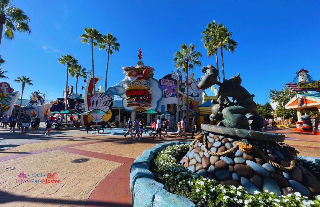 Universal Orlando Resort Toon Lagoon Cartoon Land at Islands of Adventure Popeye Statue and Blondies Restaurant. Keep reading to learn how to plan a day at Universal with this Islands of Adventure 1 day itinerary!