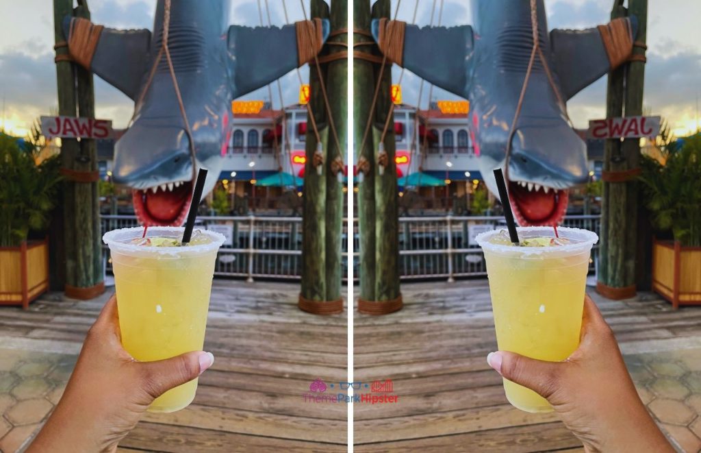 Universal Orlando Resort a margarita at Chez Alcatraz with Jaws Bruce the Shark in background at Universal Studios. One of the best photo spots in Universal Orlando.