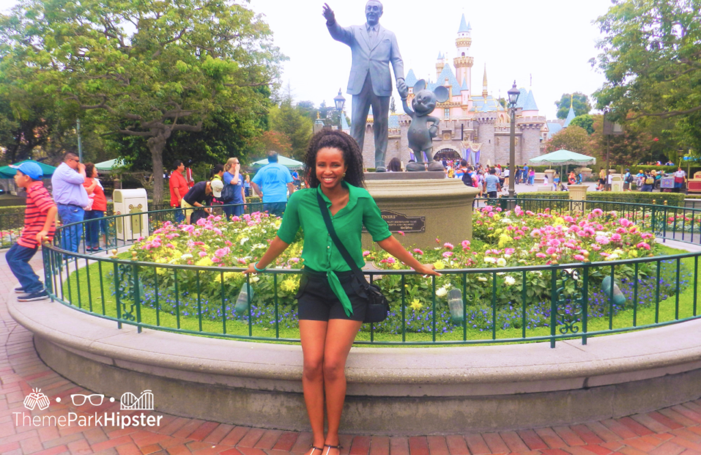 Disneyland Outfit ideas with NikkyJ and Walt and Mickey Mouse Statue. Keep reading for your own Disneyland Itinerary and planner!