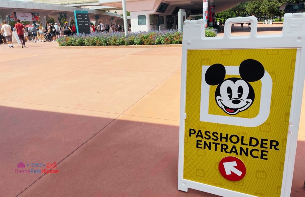 Passholder Entrance during a Disney World Festival with a photo of Mickey on a yellow and white sign with a red arrow., Keep reading to find out all you need to know about STK Disney Springs.