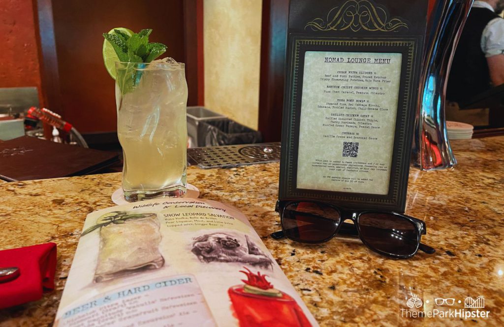 Nomad Lounge at Disney's Animal Kingdom Theme Park Snow Leopard Salvation Cocktail Drink and Menu. One of the best alcoholic drinks at Animal Kingdom. 