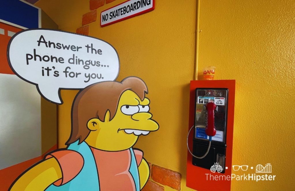 Universal Orlando Resort bully next to phone at Simpsons Land in Universal Studios. Keep reading to know if there is free WiFi at Universal Studios Orlando.