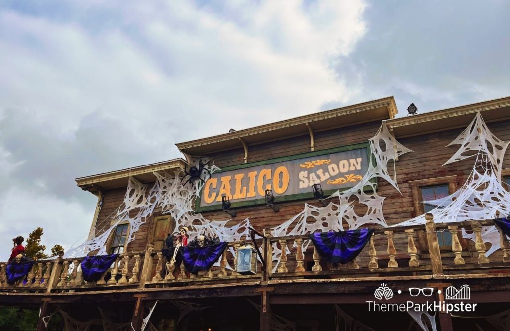 Calico Saloon entrance decorated with cobwebs at Knott's Berry Farm at Halloween Knott's Scary Farm. Keep reading to find out more about Knott’s Scary Farm houses.