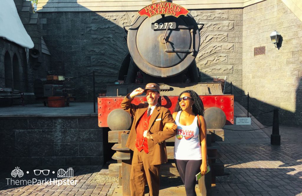 NikkyJ in front of Hogwarts Express Harry Potter World Hogsmeade at Universal Islands of Adventure