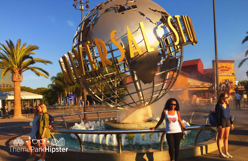 NikkyJ in front of the Globe Universal Studios Hollywood California. Keep reading to get the best Universal Studios Hollywood Tips, Tricks and Secrets!
