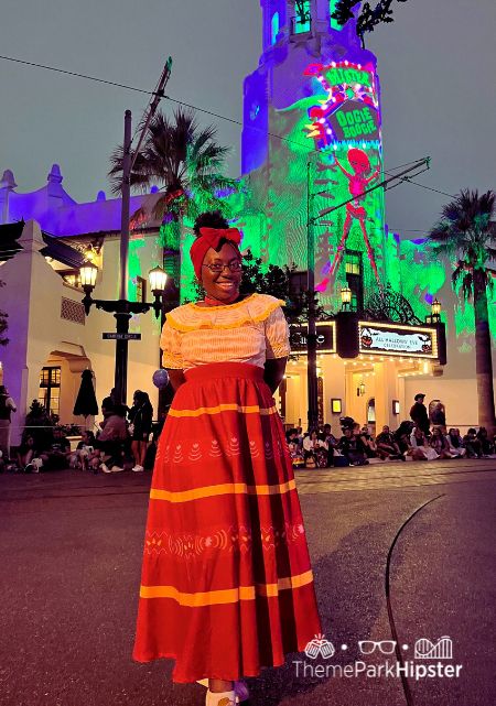 Victoria Wade as Dolores Madrigal from Encanto Disney California Adventure and Disneyland Halloween Event at Oogie Boogie Bash. Keep reading to see why I love being a solo traveler and traveling to theme parks alone.