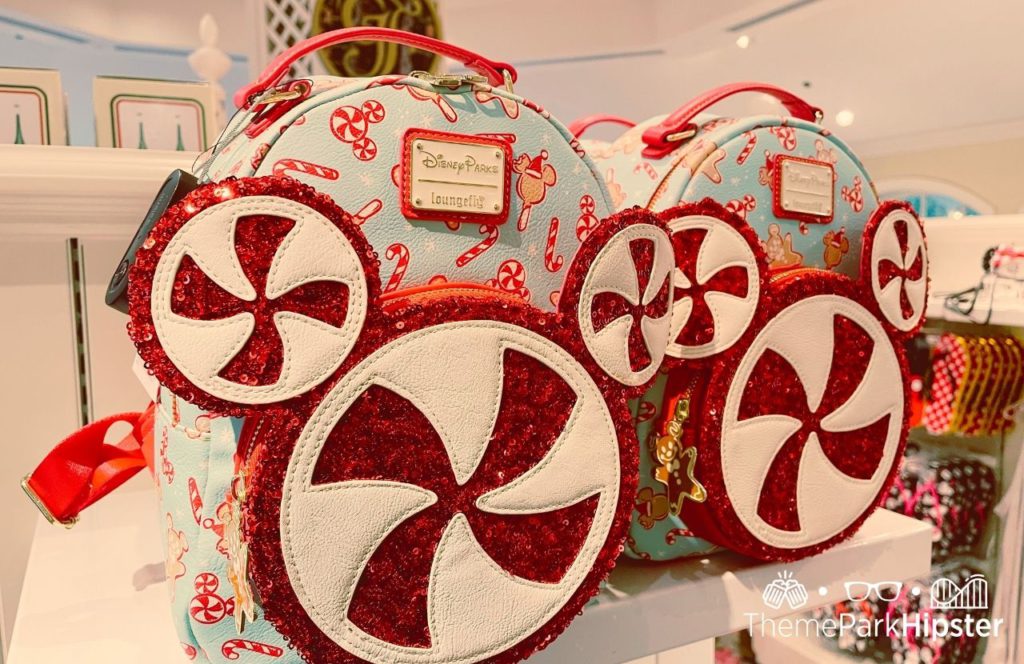 Disney Christmas Loungefly Backpack bag with swirly peppermints. Keep reading to know what to wear to Disney World in February and what to pack for Disney World in February!