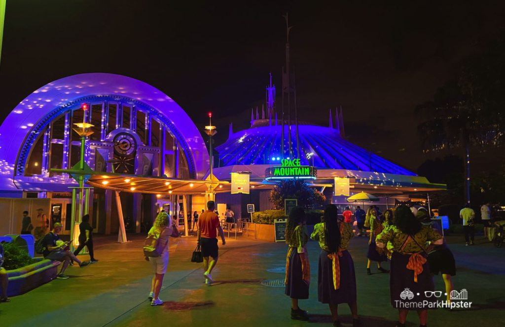 Space Mountain at Disney's Magic Kingdom Entrance at Night during Mickey's Not So Scary Halloween Party. Keep reading to figure out which is better for Space Mountain Disneyland vs Disney World.