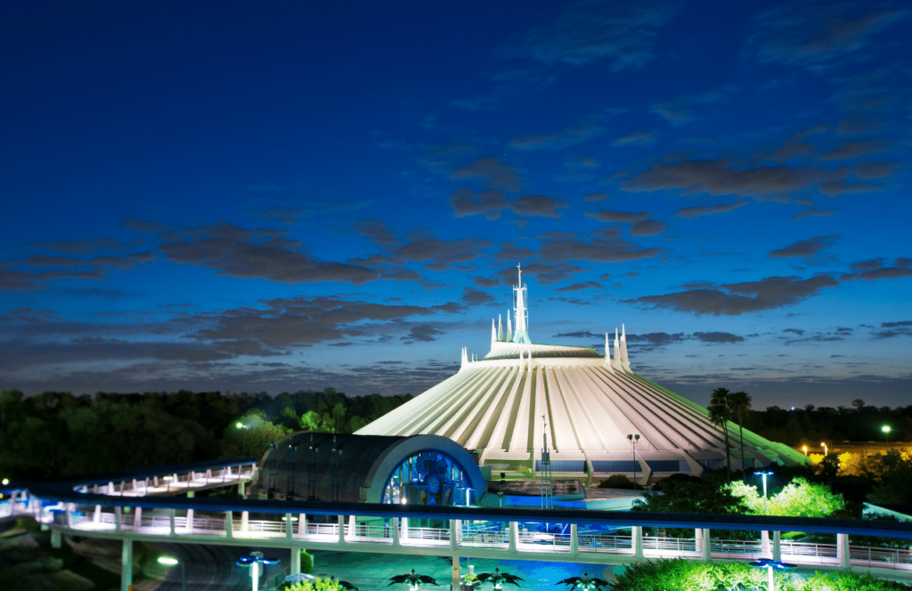Space Mountain at Magic Kingdom in Walt Disney World Florida at Night. Keep reading to figure out which is better for Space Mountain Disneyland vs Disney World.