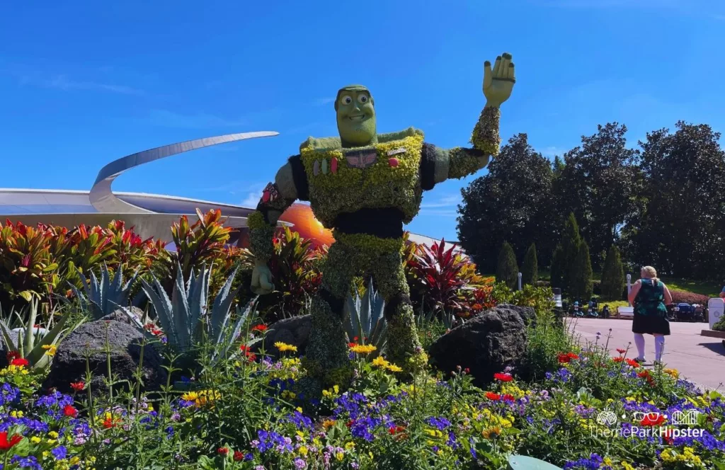Epcot Flower and Garden Festival Mission Space with Buzz Lightyear Topiary. Keep reading to get the world rides at Epcot for solo travelers on a solo disney world trip.