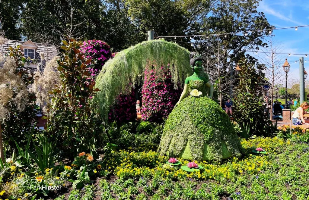 Epcot Flower and Garden Festival 2023 Princess Tiana Topiary in the American Pavilion. Keep reading to know what to pack and what to wear to Disney World in June for your packing list.