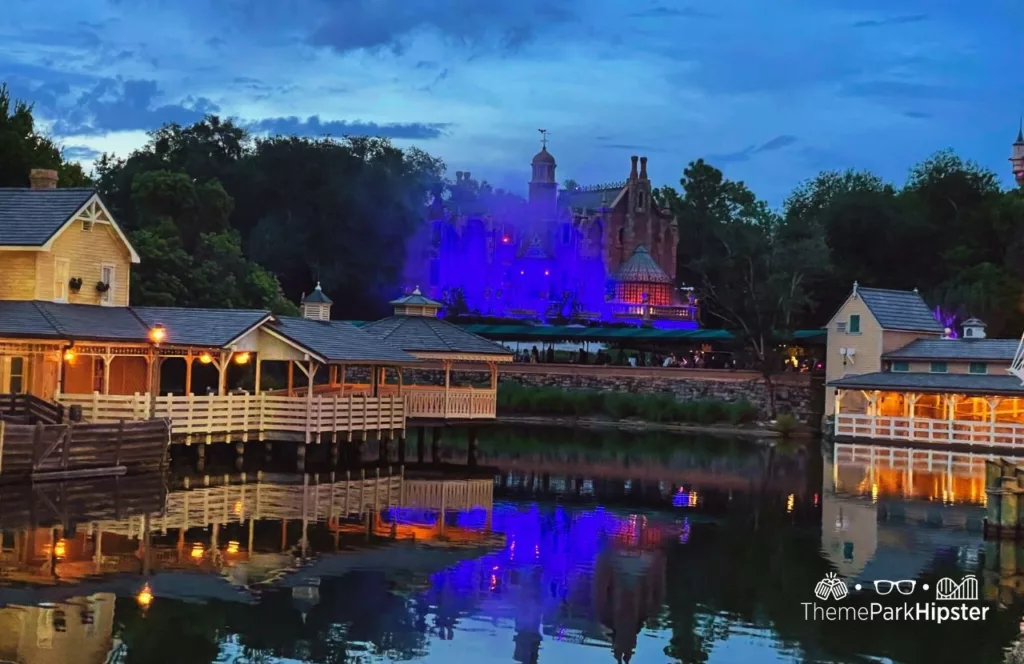Mickey's Not So Scary Halloween Party tickets at Disney's Magic Kingdom Theme Park Tom Sawyer Island and Haunted Mansion at Night over the lagoon