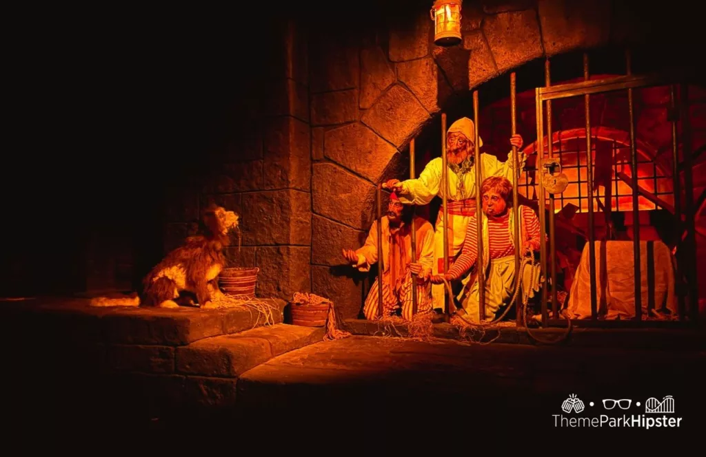 Mickey's Not So Scary Halloween Party at Disney's Magic Kingdom Theme jail scene with dog holding the key on the Park Pirates of the Caribbean ride. One of the best attractions and rides at Adventureland.