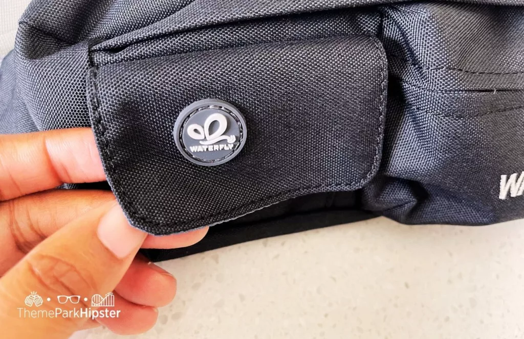 One of the best fanny packs for Disney World is Waterfly gray waist pack front pocket