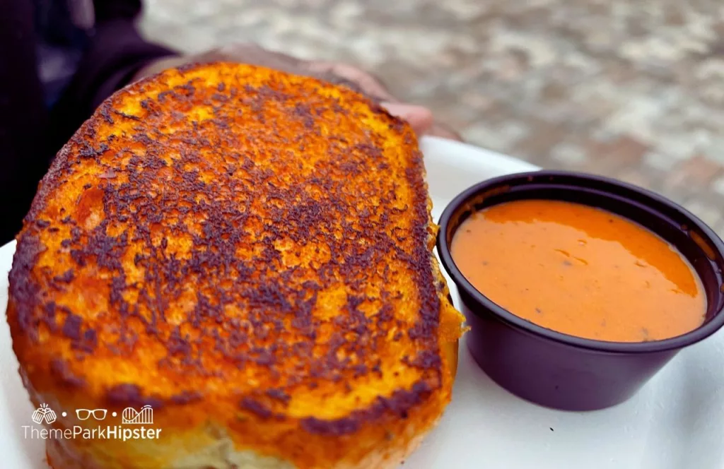 SeaWorld Orlando Christmas Celebration Grilled Cheese Sandwich with tomato dipping soup. Keep reading to find out more about SeaWorld Orlando Christmas Celebration food.