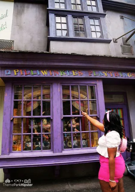 Best Spots for Wizarding World of Harry Potter Photos with Victoria Wade Playing with Wand at Pilliwinkles in Diagon Alley