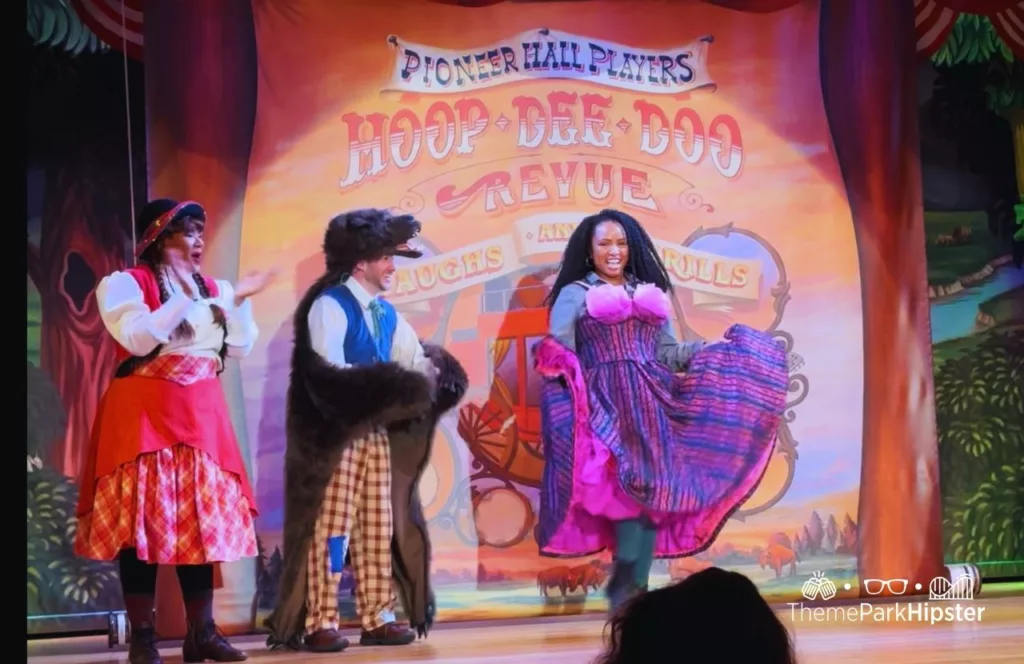 Disney Wilderness Lodge Resort NikkyJ performing on stage at Hoop Dee Doo Musical Revue. Keep reading to learn how to go to a theme park alone.