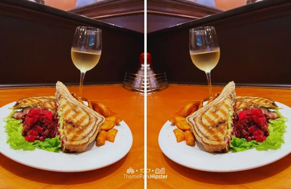 Universal Orlando Resort Finnegans Bar and Grill at Universal Studios Florida with a double photo of a glass of wine and plate of Irish American cuisine, grilled sandwich, salad, and vegetables. Keep reading to discover what are the best bars at Universal Orlando.