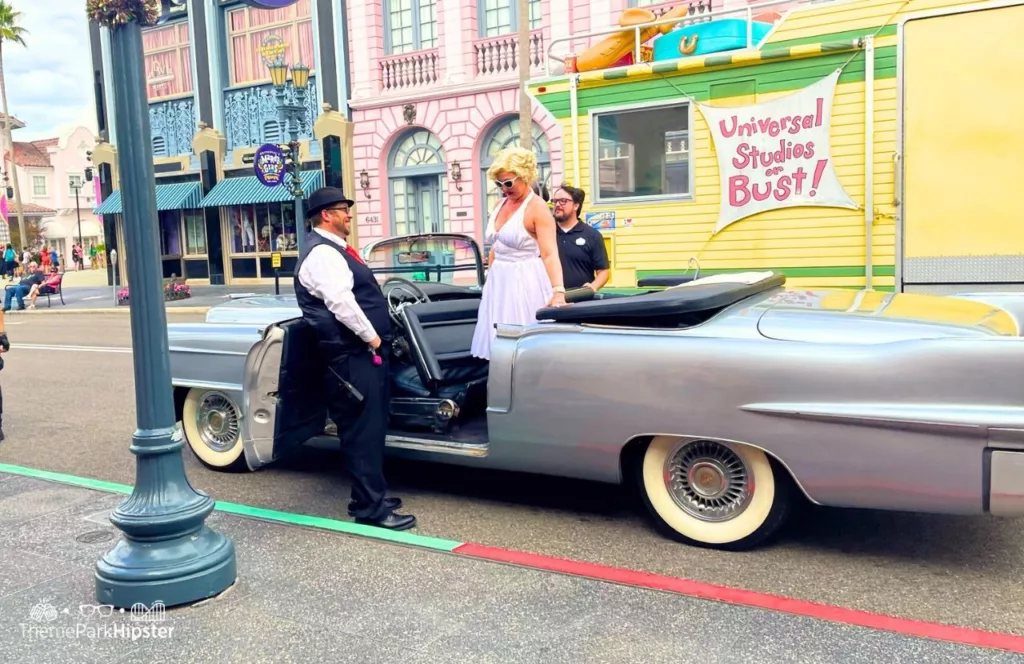 Universal Orlando Resort Maryland Monroe Character at Universal Studios Florida stepping out of a vintage car with a man holding the door open for her. Keep reading to find out 10 things to know before you go to Universal Orlando in 2024.