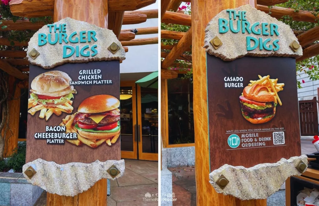 Universal Orlando Resort The Burger Digs Grilled chickend bacon cheeseburger and casado burger in Jurassic Park at Islands of Adventure on Rainy Day. Keep reading to get the full guide to the Universal Orlando Mobile Order Service.