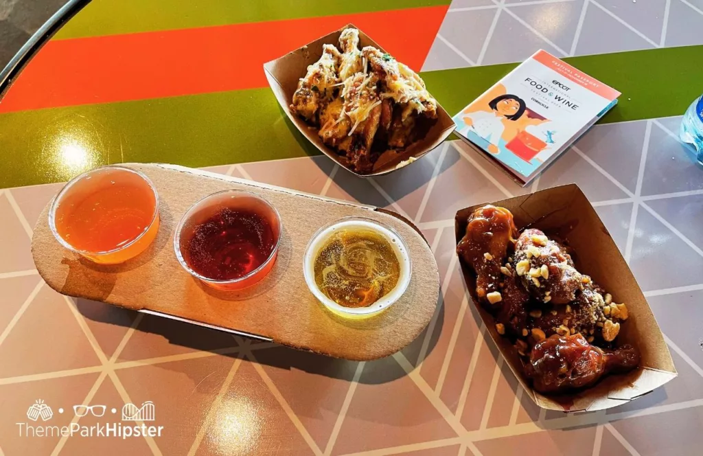 2024 Epcot Food and Wine Festival at Disney Odyssey Cider Flight with Parmesan and Peanut Butter and Jelly Chicken Wings