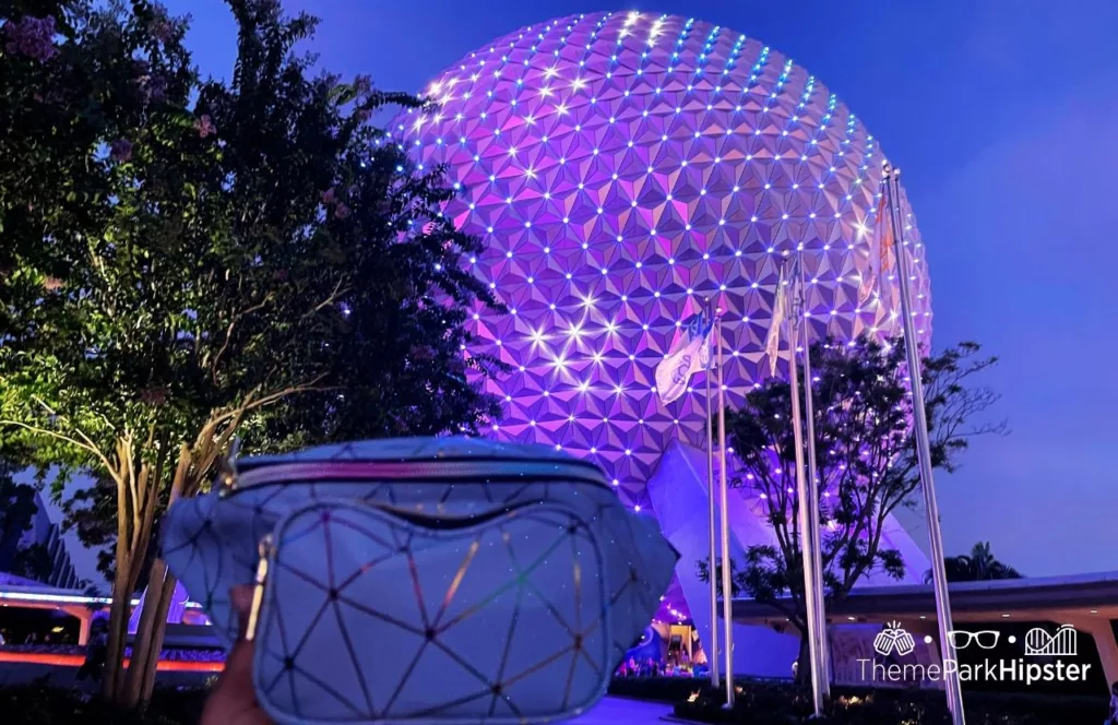Epcot Food and Wine Festival at Disney Spaceship Earth and Fanny Pack at Night. One of the Solo Travel Essentials You MUST HAVE to Stay Safe at Walt Disney World