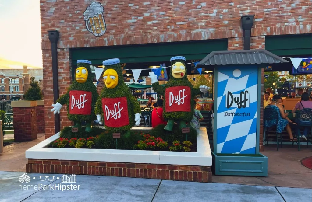 Dufftoberfest Beer in Simpsons Land at Universal Studios Orlando with three characters created to be part of the topiary and garden dressed as Duff beer bottles. Keep reading to find out more about the best lounges at Universal Orlando.