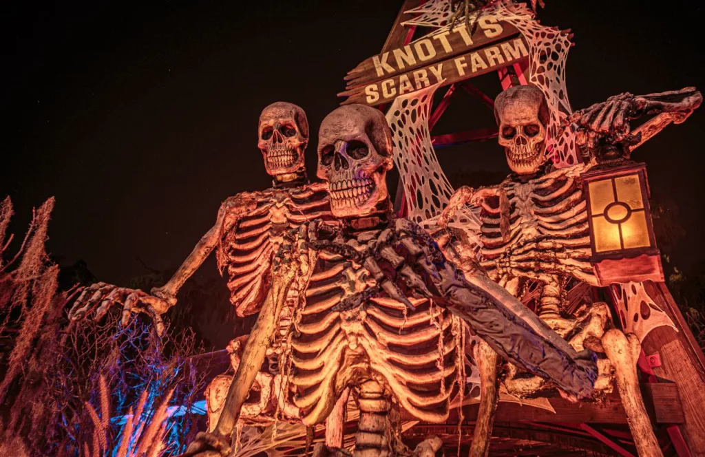  Knott's Berry Farm in California entrance with a Halloween display of skeletons for 2023 Knott's Scary Farm. Keep reading to find out all you need to know about Knott’s Scary Farm houses.