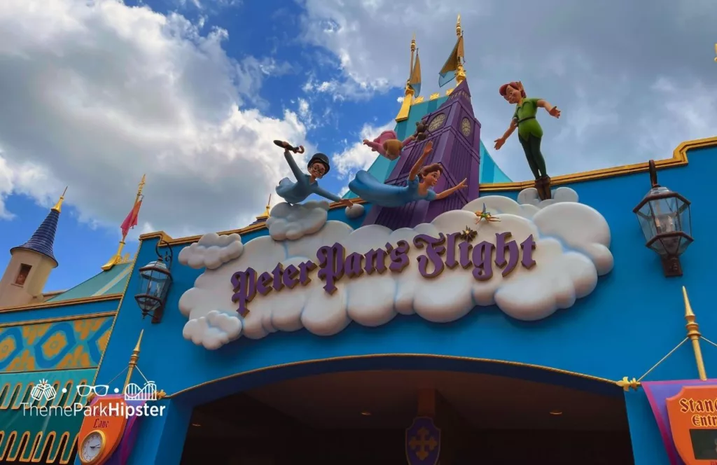 Disney Magic Kingdom Theme Park Fantasyland Peter Pan Flight Ride with characters in flight above the sign. Keep reading if you want to find out more about how to choose the best purse for Disney.