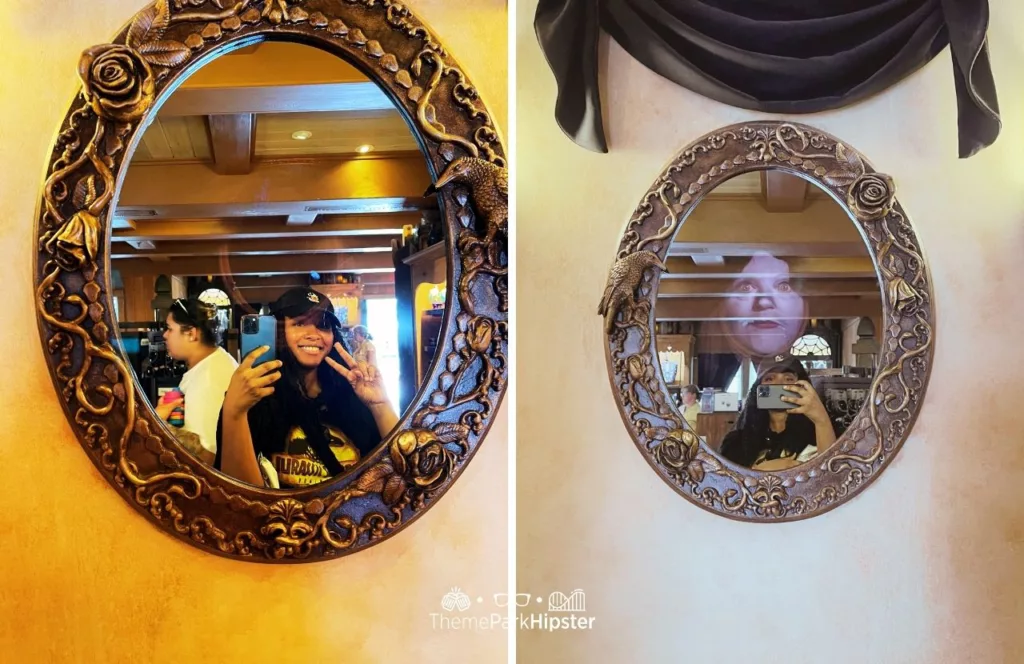 NikkyJ at Disney Memento Mori Store Haunted Mansion Merchandise at Magic Kingdom Theme Park looking into the secret mirror and Madame Leota Painting.  Keep reading to find out the best Disney purses.