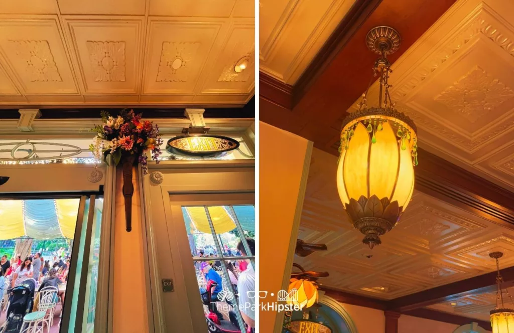 Princess and the Frog Tiana's Palace Restaurant at Disneyland of interior with floral arrangements on the wall and lighting fixtures with intricate designs. Keep reading to discover more about Tiana’s Palace Disneyland.  