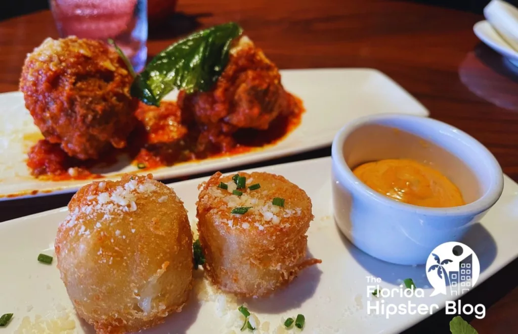 STK Orlando Wagyu Meatballs and Tater Tots with sauce. Keep reading to find out all you need to know about STK Disney Springs.