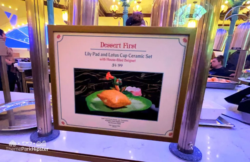 Tiana's Palace Restaurant at Disneyland from Princess and the Frog Dessert First Lily Pad and Lotus Cup with BeignetKeep reading to find out more about Tiana’s Palace food.