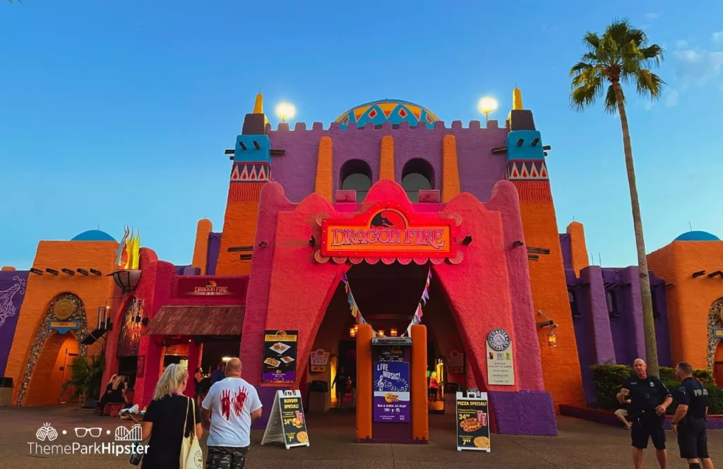 Dragon Fire Grill Restaurant during 2023 Howl O Scream at Busch Gardens Tampa Bay with menus on display outside and theme park guests standing around. Keep reading discover more about the best things to eat at Busch Gardens Tampa.