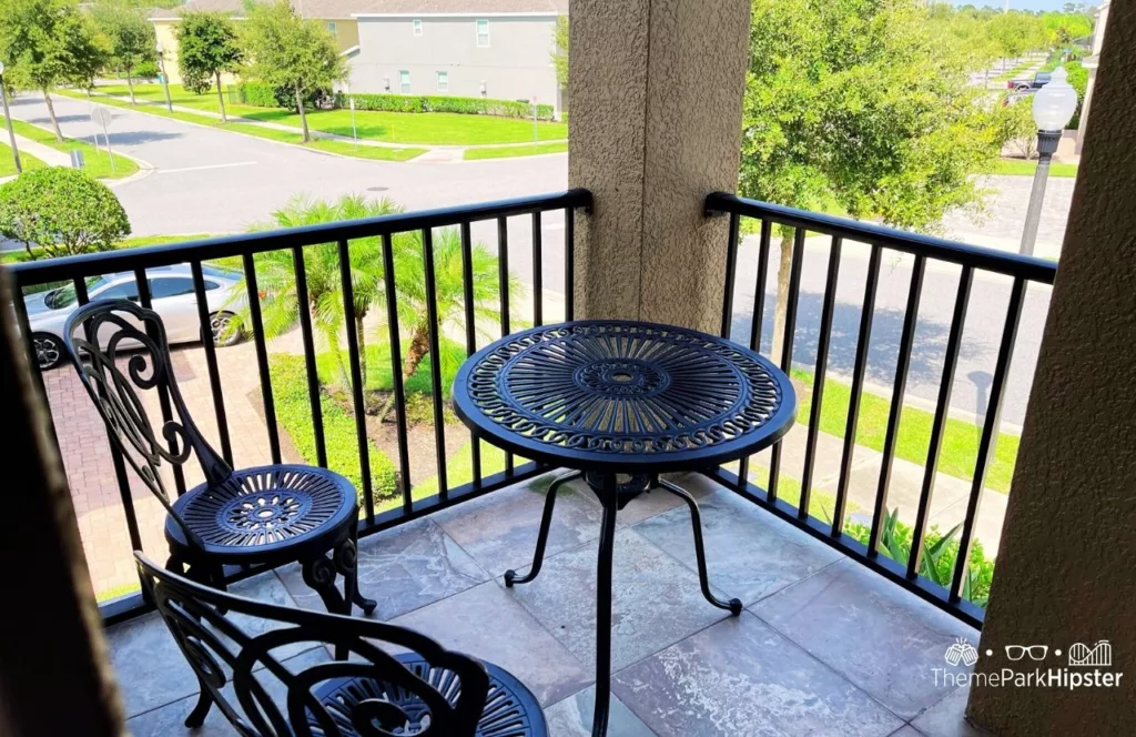 Balcony in 5 Bedroom Villa with bistro table set overlooking the street. Keep reading to learn more about Encore Resort Orlando.
