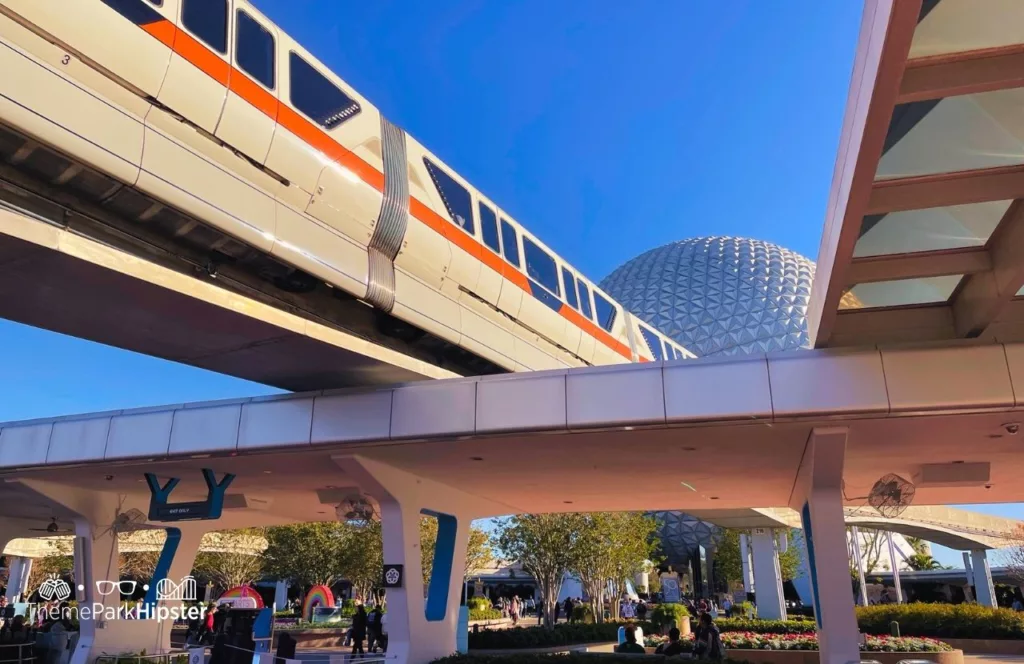Disney Monorail Transportation at Epcot passing by entrance and Spaceship Earth. One of the Epcot Rides. Keep reading to get the best Disney World Tips to Make Your Solo Trip to Orlando, Florida Easier.