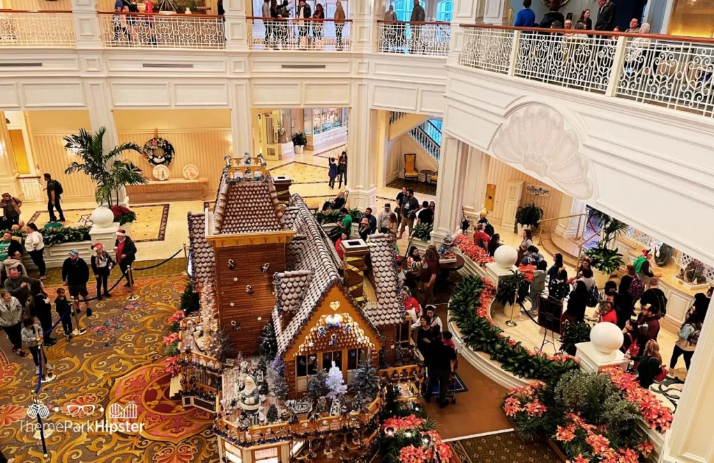Holiday Tree and Gingerbread house at Disney Grand Floridian Resort and Spa at Christmas. Keep reading to learn about the Disney World Gingerbread house display on Theme Park Hipster!