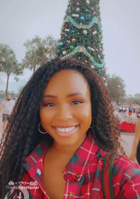 NikkyJ in front of tree at 2023 Disney Christmas at Epcot Festival of the Holidays