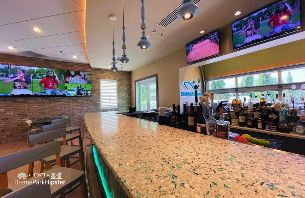 Shark Lounge and bar area at Encore Resort with overhead mounted large screen television. Keep reading to learn more about Encore Resort.  