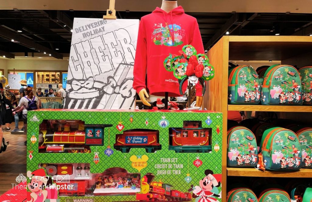 Red Disney World Christmas Sweater Loungefly Bag and Train. One of the best Disney Christmas gifts!